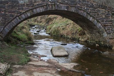 Arch bridge over river stream