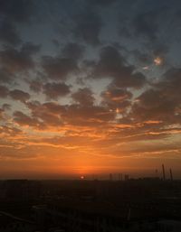 Silhouette buildings against sky during sunset