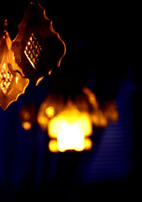 Close-up of illuminated lamp at night