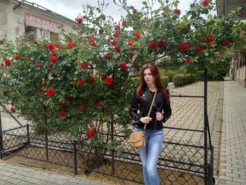 Full length of woman standing against plants