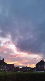 Built structure against cloudy sky at sunset