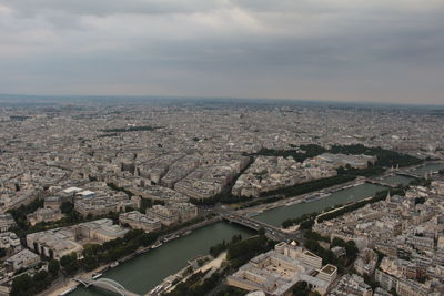 High angle view of river and buildings against sky