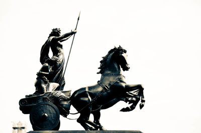 Low angle view of horse statue against clear sky