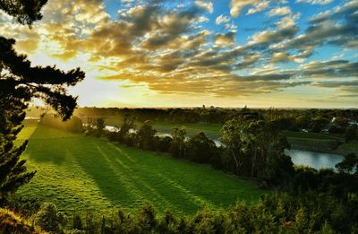 Scenic view of field against cloudy sky