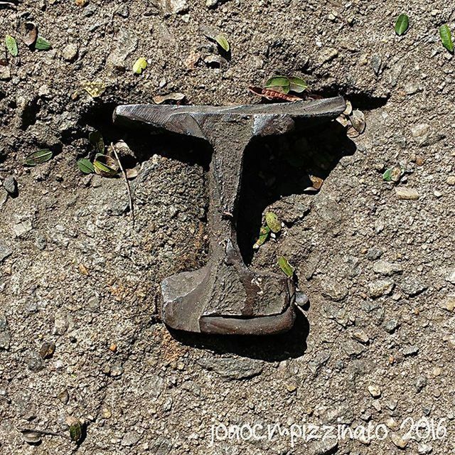 high angle view, textured, abandoned, old, outdoors, day, wall - building feature, close-up, no people, ground, leaf, street, damaged, shoe, weathered, sunlight, wall, obsolete, nature, plant