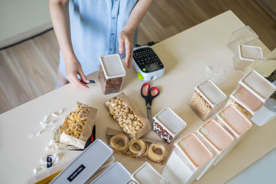 High angle view of woman preparing food on table