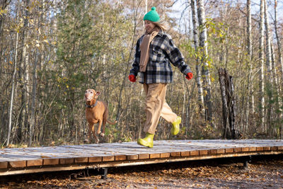 Full length of woman walking on footbridge