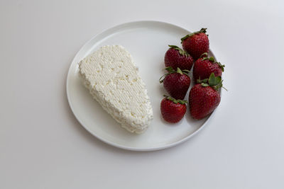 High angle view of strawberries in bowl against white background