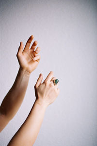 Close-up of woman hand over white background