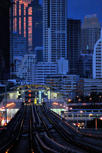 Empty road along urban buildings