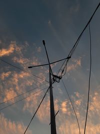 Low angle view of electricity pylon against sky