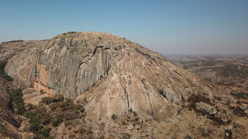 Panoramic view of rocky mountains against clear sky
