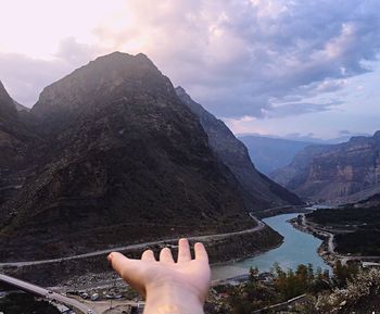 Sun shining over mountain lake in front of mountains