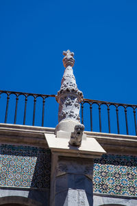 Low angle view of statue against clear blue sky