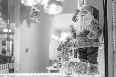 Woman standing by illuminated lights