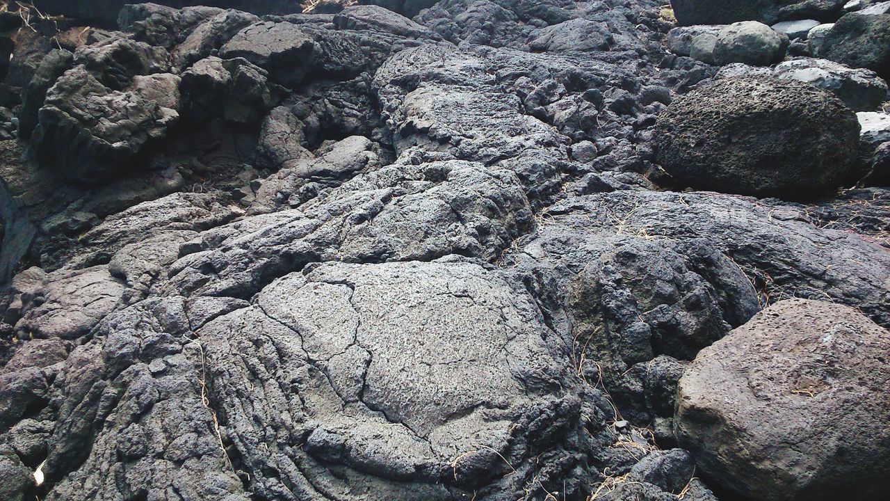 FULL FRAME SHOT OF ROCKS ON LAND