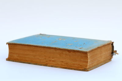 Close-up of book on table against white background