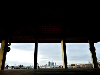 View of city buildings against cloudy sky