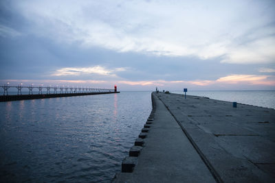 Scenic view of pier and lake michigan  at white haven,  against sky during sunset