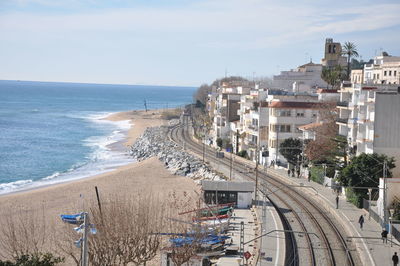 Scenic view of sea by city against sky