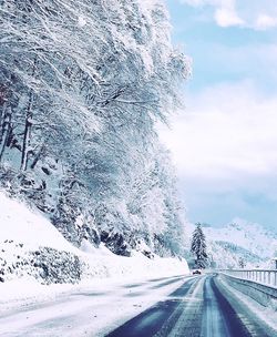 Snow covered road against sky