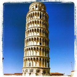 Low angle view of building against clear blue sky