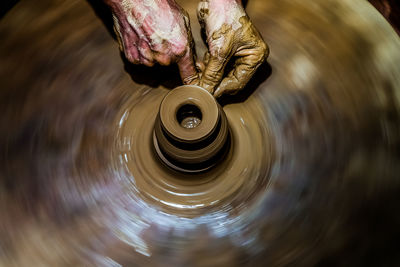 Cropped image of person making pottery in workshop