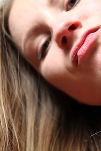 Close-up portrait of young woman puckering lips