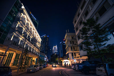 Illuminated city street and buildings at night