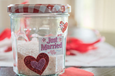 Close-up of jar with text on table