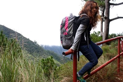 Side view of young woman standing on land