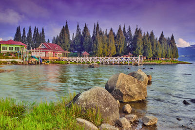 Scenic view of lake by building against sky