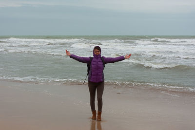 Young woman beach seagulls. cinematic neutral winter plot. a happy woman walks along a sandy beach,