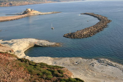 High angle view of rocks on sea shore