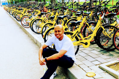 Portrait of smiling man sitting on bicycle