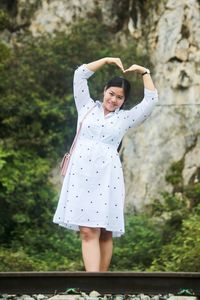 Portrait of a smiling young woman standing outdoors