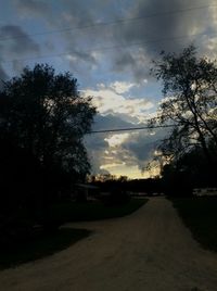 Empty road against cloudy sky