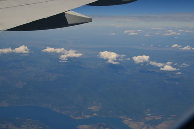 Aerial view of clouds over airplane wing