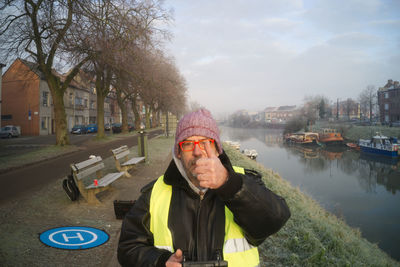 Portrait of man standing in canal