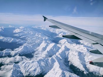 Aerial view of snowcapped mountain against sky