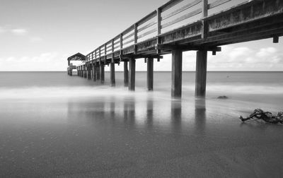 Pier on sea against sky