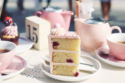 Close-up of cake slices with coffee served on table