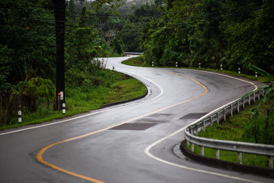 Empty road amidst trees