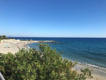 Scenic view of sea against clear blue sky