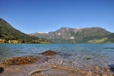 Scenic view of beach against blue sky