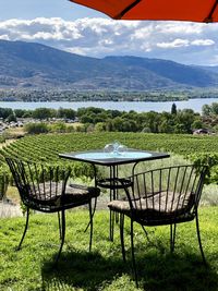 Chairs and tables on table against mountains