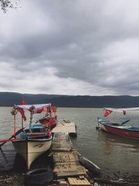Boats moored on sea against sky