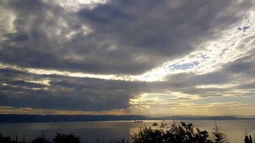 Scenic view of lake against dramatic sky