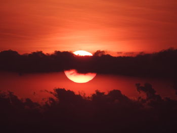 Scenic view of silhouette trees against romantic sky at sunset