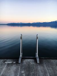 Scenic view of lake against sky at sunset